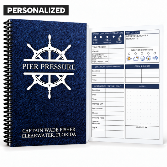 Personalized navy Captain’s Logbook with white ship’s wheel, custom boat name, black spiral binding, and guided boating log page.
